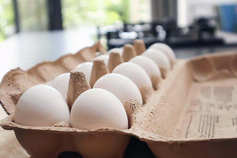 carton of white eggs on countertop